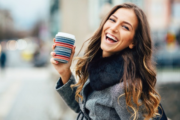 Young woman with coffee in hand